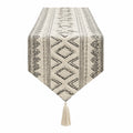 Chemin de table 180 x 33 cm textile tissé beige noir motif géométrique avec pompons